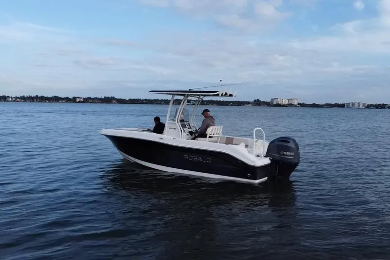 Slide: The Image of 2016 Robalo R200 Center Console boat on calm water with two people onboard. - 18