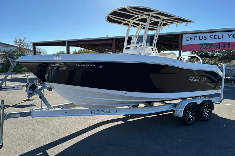 Slide: The Image of 2016 Robalo R200 Center Console boat on trailer, displayed outdoors. - 5