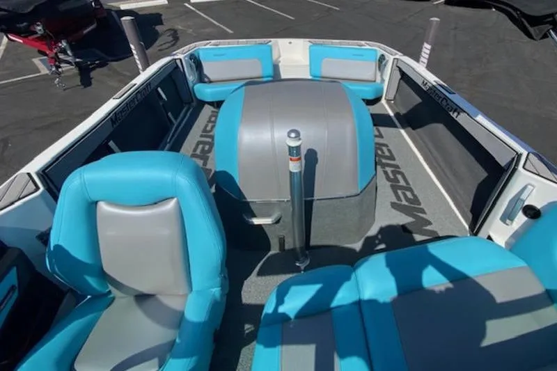 Slide: The Image of 2018 MasterCraft ProStar boat interior with blue and gray seating, showcasing spacious design. - 2