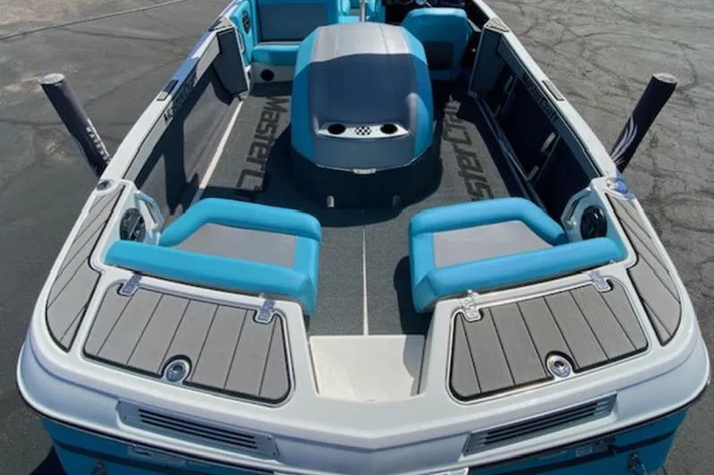 Slide: The Image of 2018 MasterCraft ProStar boat interior with blue and gray seating, viewed from above. - 4