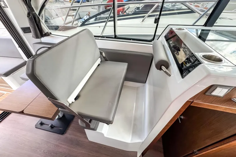Slide: The Image of 2024 Beneteau Antares 11 interior helm with modern seating and controls. - 15