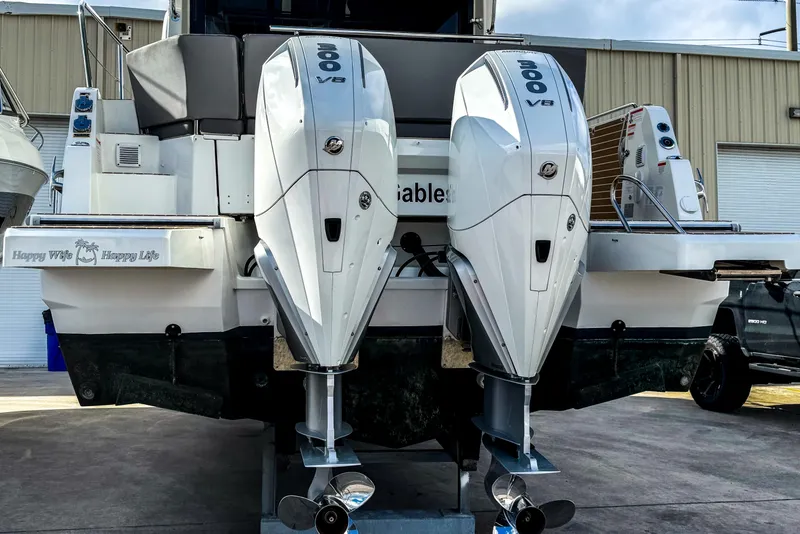 Slide: The Image of 2024 Beneteau America Antares 11 with dual 300 V8 engines, docked outdoors. - 2