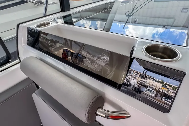 Slide: The Image of 2024 Beneteau America Antares 11 interior with modern dashboard and cup holders. - 22