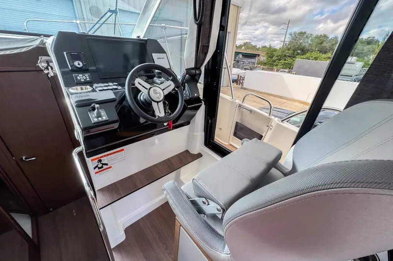 Slide: The Image of 2024 Beneteau America Antares 11 helm station with modern controls and comfortable seating. - 23
