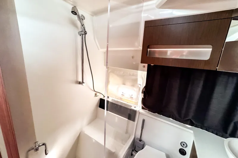 Slide: The Image of 2024 Beneteau Antares 11 bathroom with shower, modern fixtures, and wooden cabinetry. - 32
