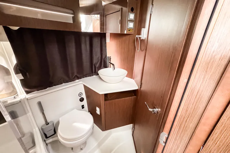 Slide: The Image of 2024 Beneteau Antares 11 bathroom with modern fixtures and wood accents. - 33