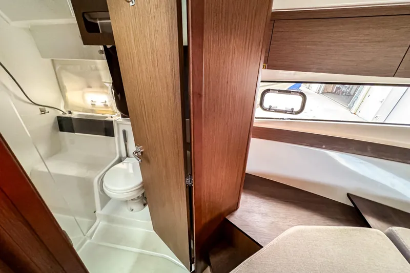 Slide: The Image of 2024 Beneteau Antares 11 interior with modern bathroom and wooden finishes. - 34