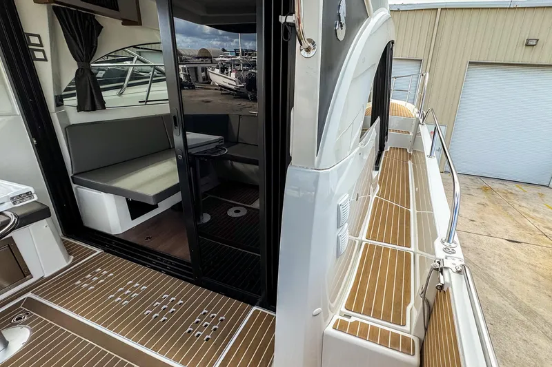 Slide: The Image of 2024 Beneteau Antares 11 boat interior with seating and deck view. - 36
