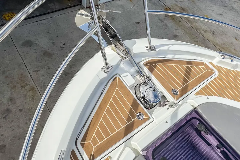 Slide: The Image of 2024 Beneteau America Antares 11 boat deck with wood accents and anchor system. - 38