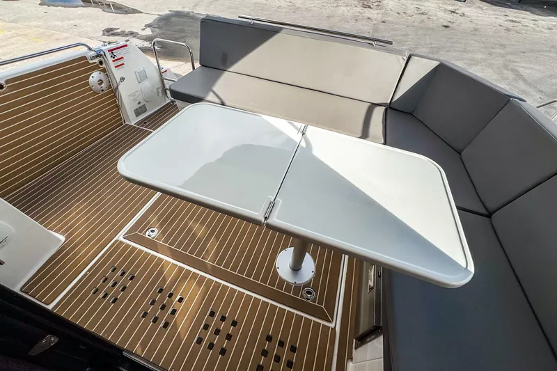 Slide: The Image of 2024 Beneteau Antares 11 boat interior with seating and foldable table. - 4