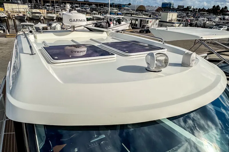 Slide: The Image of 2024 Beneteau Antares 11 boat roof with Garmin equipment at marina. - 40