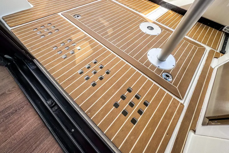 Slide: The Image of 2024 Beneteau Antares 11 boat deck with wood finish and metal fixtures. - 5