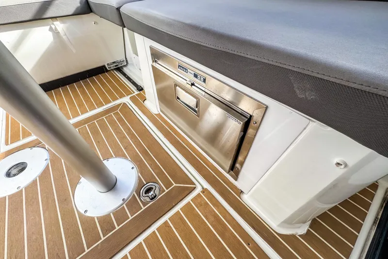 Slide: The Image of 2024 Beneteau Antares 11 interior with wood flooring and built-in storage. - 6