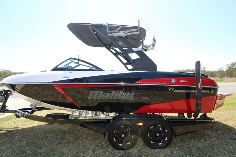 Slide: The Image of 2018 Malibu Wakesetter 20 VTX boat on trailer, black and red design. - 3