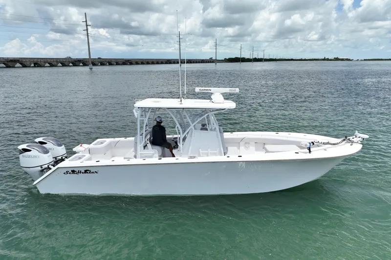 The Image of 2023 SeaHunter 31 Tournament boat on water, featuring dual Suzuki engines. - 1