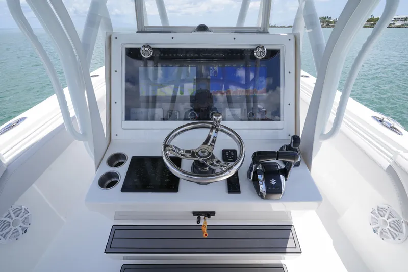 Slide: The Image of 2023 SeaHunter 31 Tournament boat helm with advanced navigation and control systems. - 13