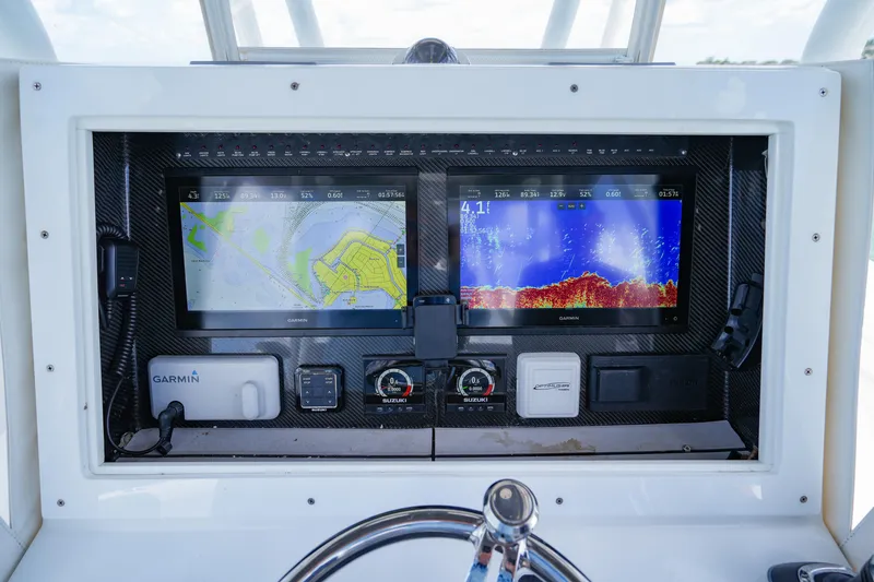 Slide: The Image of 2023 SeaHunter 31 Tournament dashboard with Garmin navigation and sonar displays. - 16