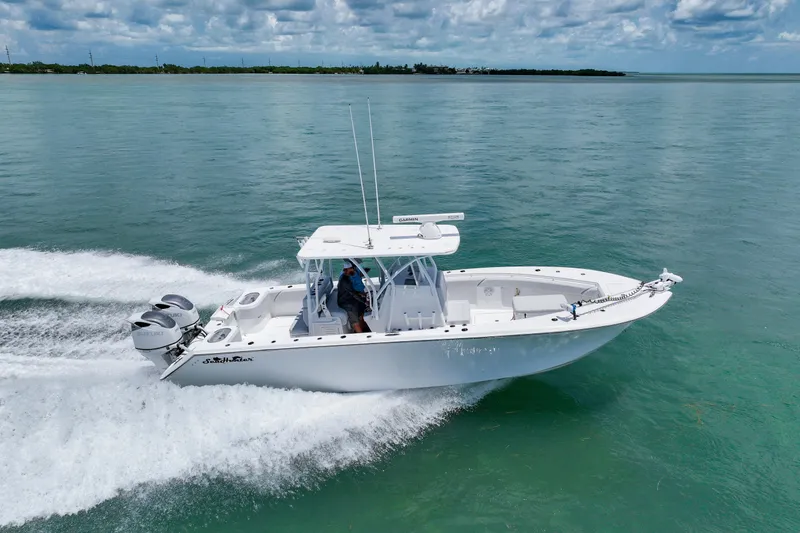 Slide: The Image of 2023 SeaHunter 31 Tournament boat cruising on open water under a cloudy sky. - 6