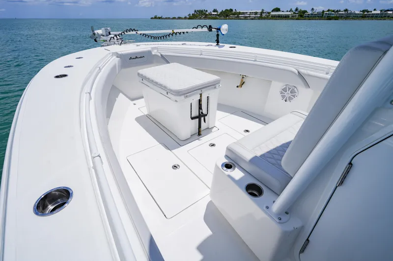Slide: The Image of 2023 SeaHunter 31 Tournament boat interior with seating and storage on calm water. - 7