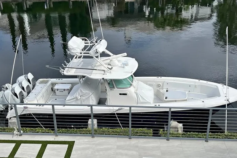 The Image of 2008 Everglades 350 Center Console boat docked by the water. - 1
