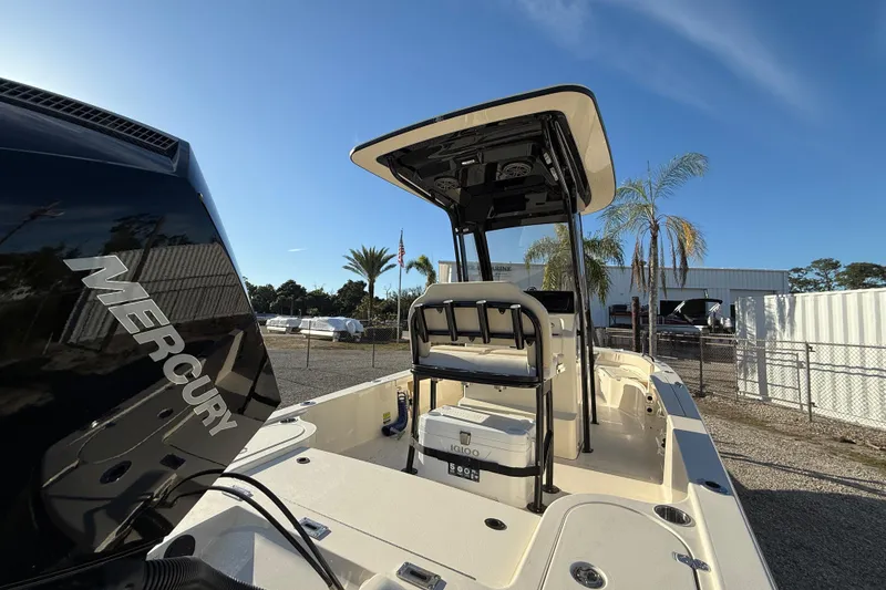 Slide: The Image of 2026 Scout 231 XSB boat with Mercury engine, outdoor setting, palm trees in background. - 4