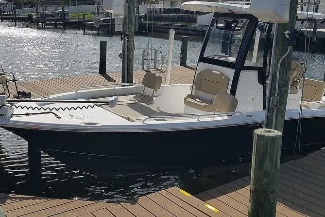 Slide: The Image of 2019 Sea Hunt BX 25 FS boat docked at marina, featuring sleek design and spacious seating. - 6