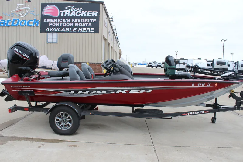 The Image of 2023 Tracker Pro Team 175 TXW boat on trailer, parked outside dealership. - 0