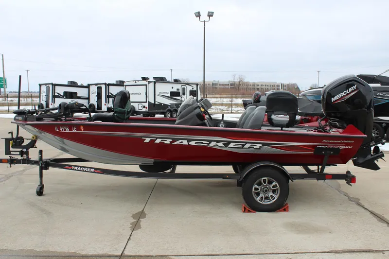 Slide: The Image of 2023 Tracker Pro Team 175 TXW boat on trailer, red exterior, parked outdoors. - 4