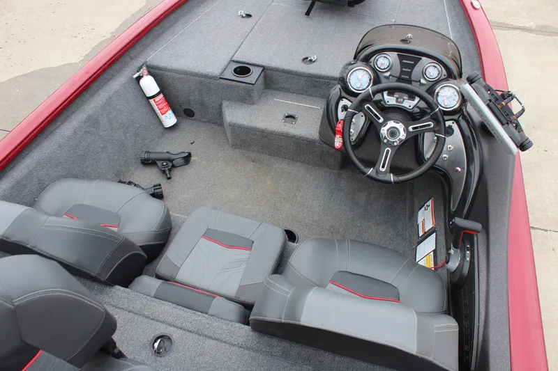 Slide: The Image of 2023 Tracker Pro Team 175 TXW boat interior with steering console and seating. - 8