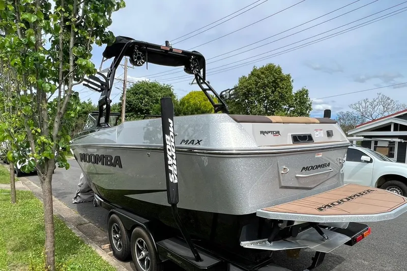 Slide: The Image of 2020 Moomba Max boat on trailer, parked on street near trees and houses. - 3