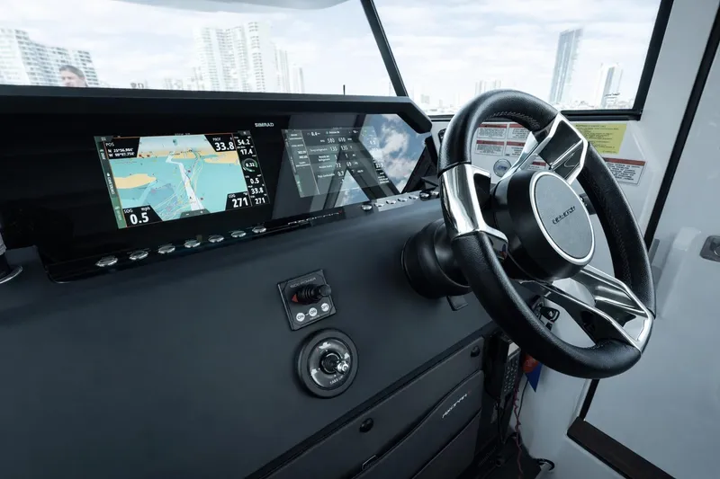 Slide: The Image of 2022 Axopar 37 XC Cross Cabin dashboard with navigation display and steering wheel. - 10