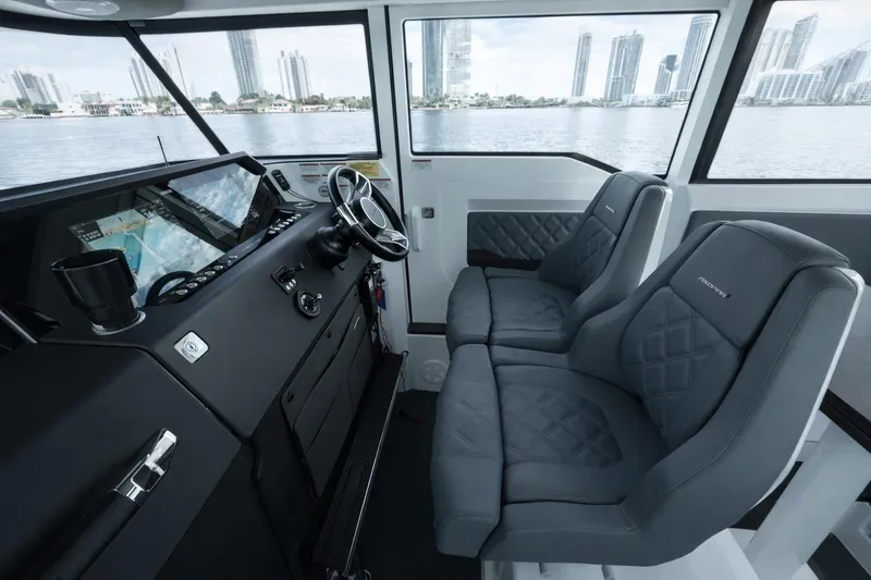 Slide: The Image of Interior of 2022 Axopar 37 XC Cross Cabin with modern dashboard and seating. - 11