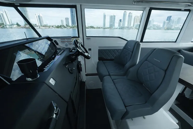 Slide: The Image of Interior of 2022 Axopar 37 XC Cross Cabin with modern seating and cityscape view. - 12