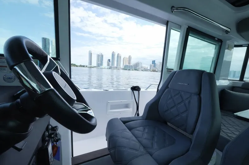 Slide: The Image of Interior of 2022 Axopar 37 XC Cross Cabin with city skyline view. - 13