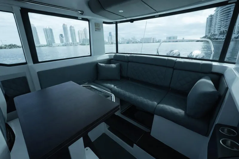 Slide: The Image of Interior of 2022 Axopar 37 XC Cross Cabin with cityscape view through windows. - 14