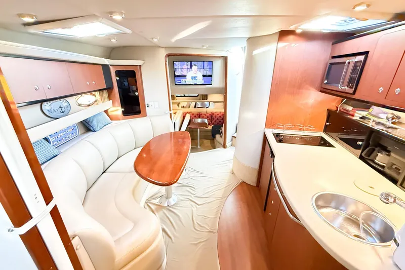 Slide: The Image of Luxurious interior of 2004 Chaparral Signature 350 yacht with modern kitchen and seating area. - 13