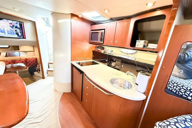 Slide: The Image of 2004 Chaparral Signature 350 yacht interior with modern kitchen and cozy seating area. - 19