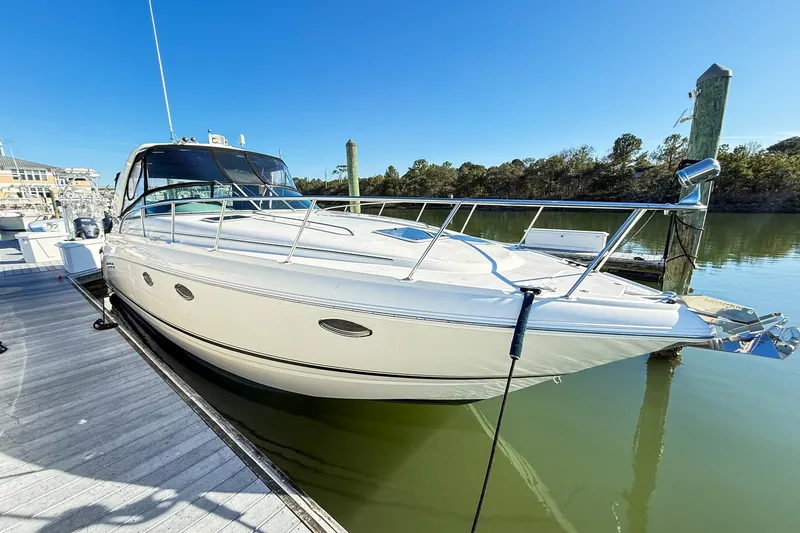 Slide: The Image of 2004 Chaparral Signature 350 boat docked on calm water under clear blue sky. - 2