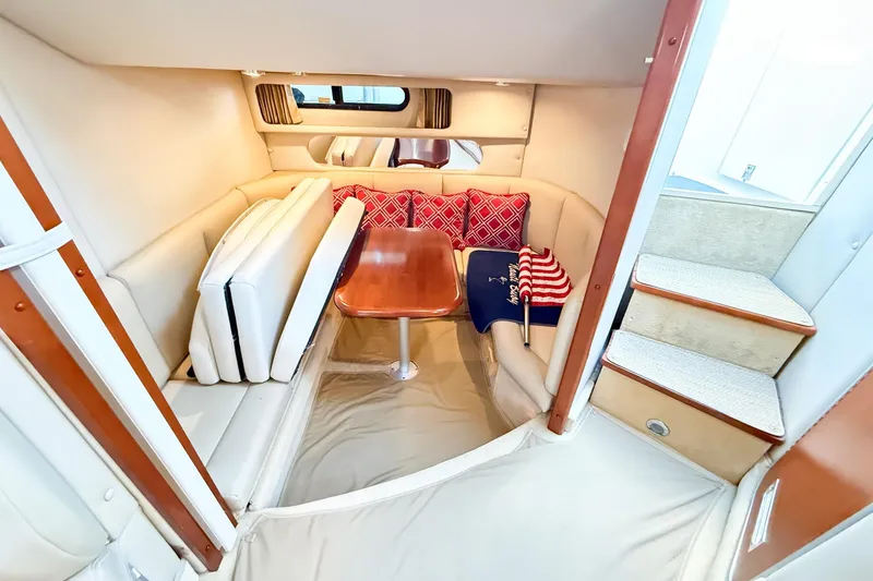 Slide: The Image of 2004 Chaparral Signature 350 cabin interior with cozy seating and wooden table. - 21