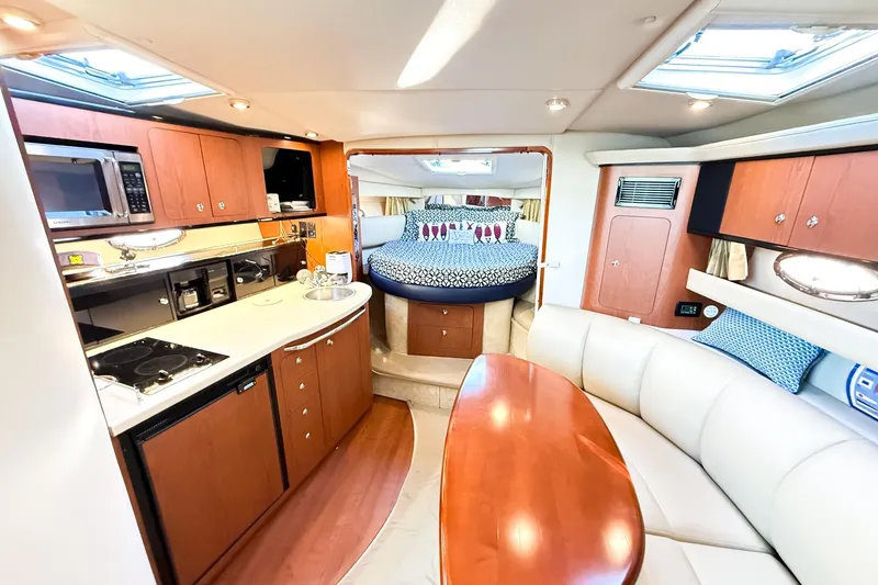 Slide: The Image of Luxurious interior of 2004 Chaparral Signature 350 yacht with kitchen and cozy seating area. - 23