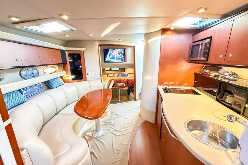Slide: The Image of Luxurious interior of 2004 Chaparral Signature 350 yacht with modern kitchen and seating area. - 24