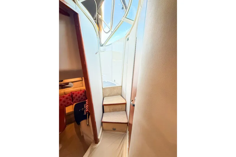 Slide: The Image of Interior view of 2004 Chaparral Signature 350 yacht, featuring stairs and cozy cabin area. - 26