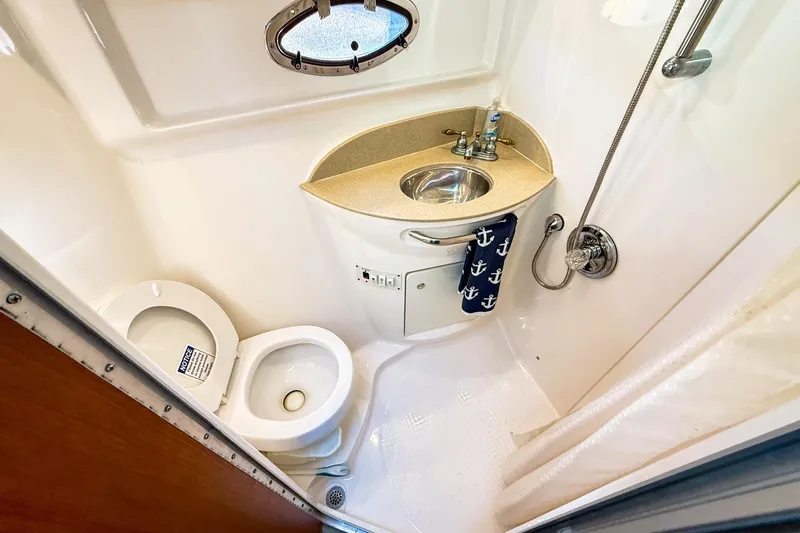 Slide: The Image of 2004 Chaparral Signature 350 bathroom with toilet, sink, and shower. - 29