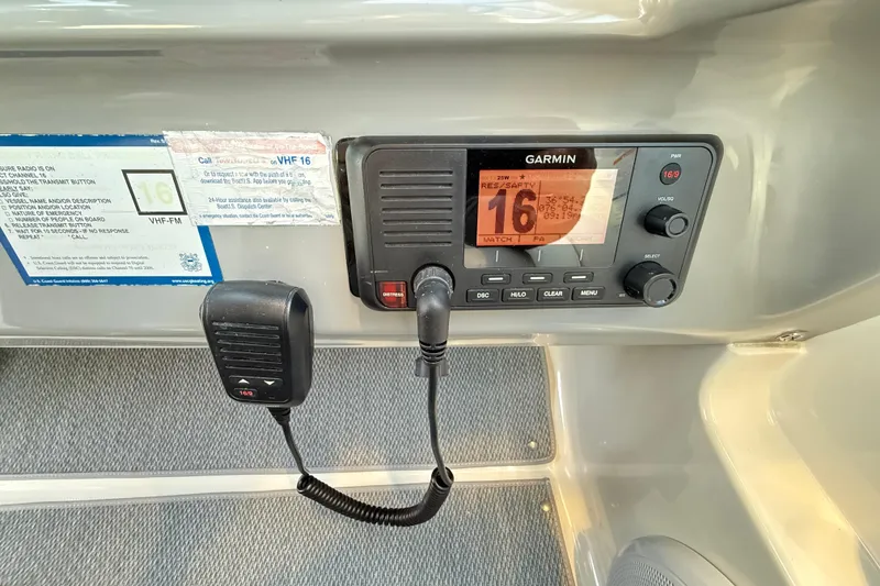 Slide: The Image of Garmin VHF radio on 2004 Chaparral Signature 350 boat dashboard. - 33