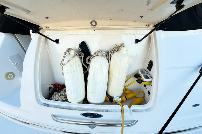 Slide: The Image of Storage compartment of 2004 Chaparral Signature 350 boat with fenders and cables. - 34