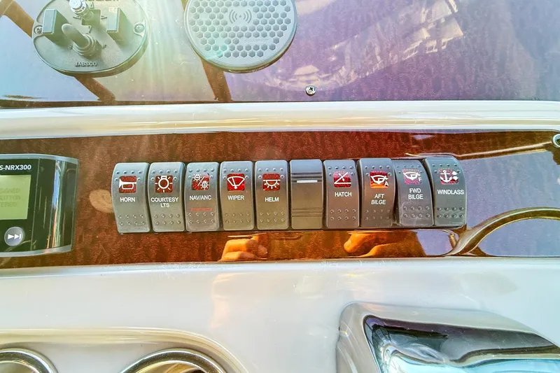 Slide: The Image of Control panel of a 2004 Chaparral Signature 350 boat with labeled switches. - 42
