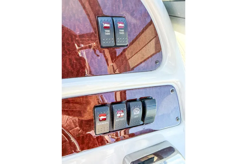 Slide: The Image of Control panel of 2004 Chaparral Signature 350 boat with switches for trim tabs and sounder. - 43