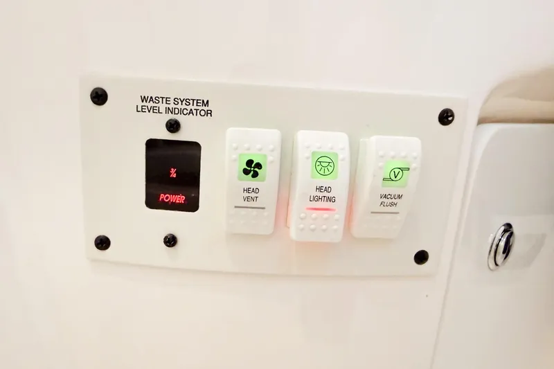 Slide: The Image of Control panel of 2004 Chaparral Signature 350 with waste system level indicator and switches. - 44