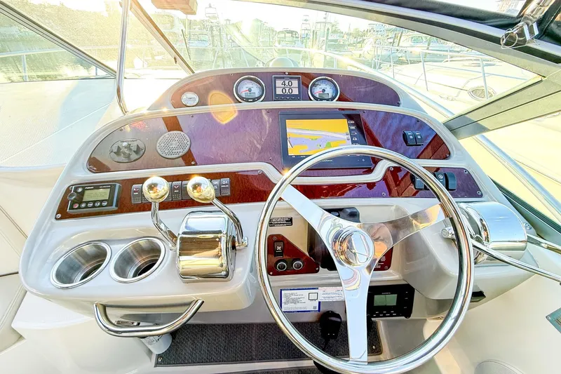 Slide: The Image of Cockpit of 2004 Chaparral Signature 350 boat with steering wheel and navigation controls. - 7