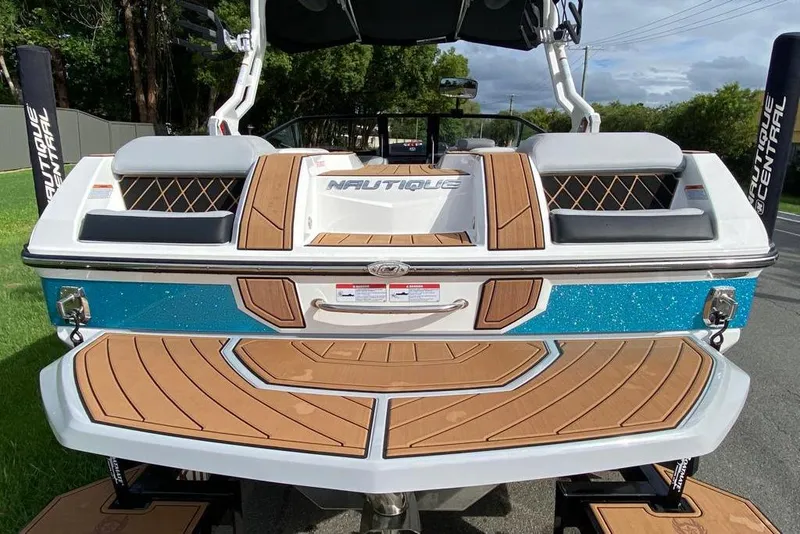 Slide: The Image of 2020 Nautique Super Air Nautique GS20 boat with teak deck and blue accents. - 3